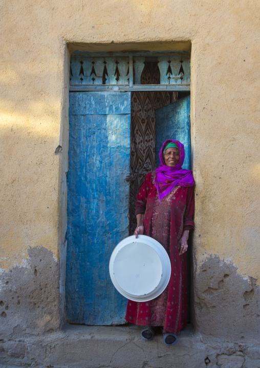 Old eritrean woman standing at the entrance of her house, Anseba, Keren, Eritrea
