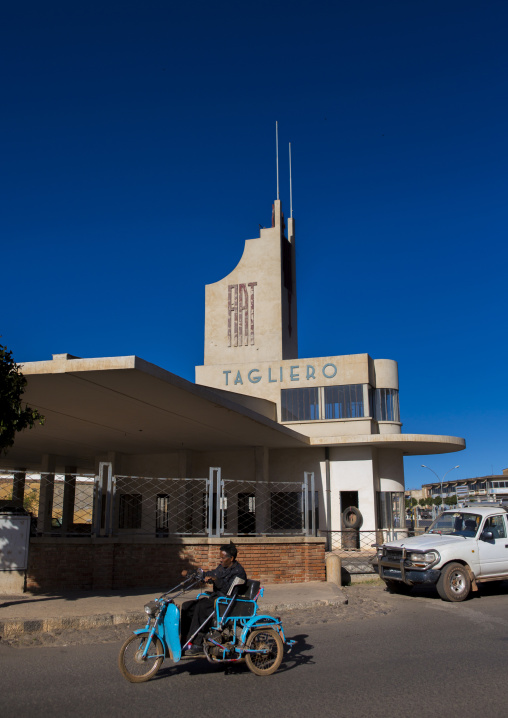 Disabled man in front of Fiat tagliero garage and service station, Central Region, Asmara, Eritrea