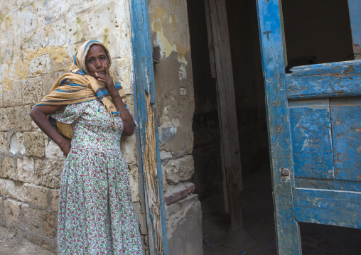 Eritrean woman standing in front of her house, Northern Red Sea, Massawa, Eritrea