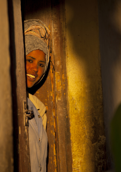 Smiling eritrean woman standing in a door, Central Region, Asmara, Eritrea