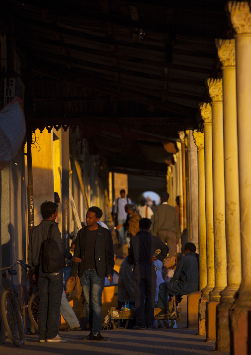 Eritrean people walking under arcades in the city center, Central Region, Asmara, Eritrea