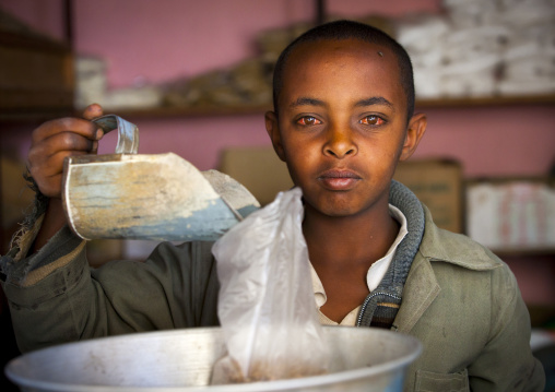 Eritrean boy with red eyes in chili shop, Debub, Adi Keyh, Eritrea
