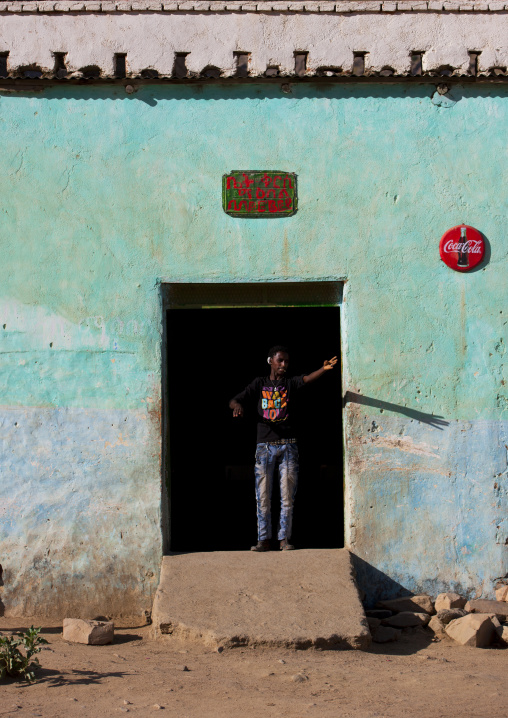 Eritrean man standing at the entrance of a bar, Anseba, Keren, Eritrea