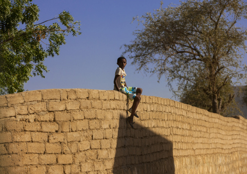 Eritrean boy sitting on a wall, Anseba, Keren, Eritrea