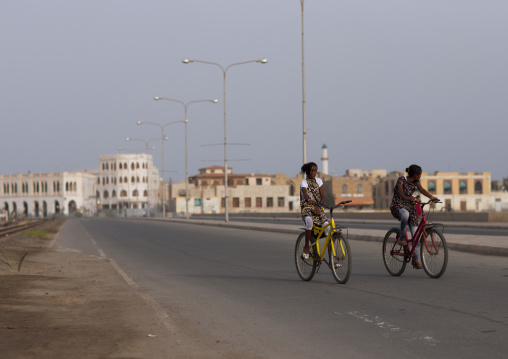 Eritrean girls riding bicycles on the causeway, Northern Red Sea, Massawa, Eritrea