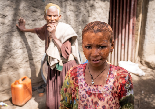 Ethiopian girl with face covered by holy soil in Bilbaia Giorgis rock-hewn church, Amhara Region, Lalibela, Ethiopia