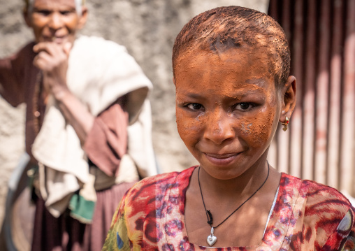 Ethiopian girl with face covered by holy soil in Bilbaia Giorgis rock-hewn church, Amhara Region, Lalibela, Ethiopia