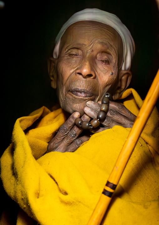 Old ethiopian nun in yellow shawl, Amhara Region, Lalibela, Ethiopia