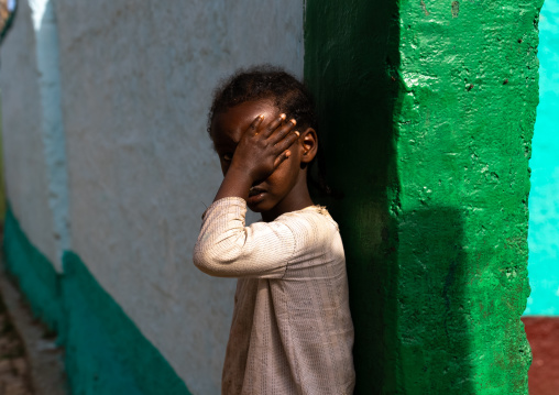 Ethiopian girl hiding her face in the street, Harari Region, Harar, Ethiopia