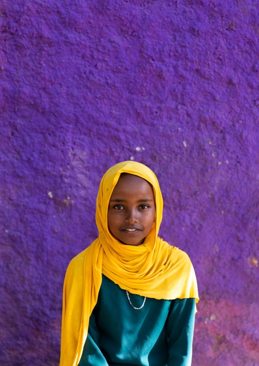 Cute ethiopian girl in front of a purple wall, Harari Region, Harar, Ethiopia
