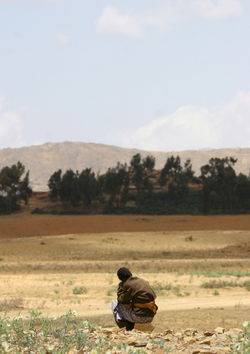 Eritrean boy sit in a field, Debub, Cohaito, Eritrea