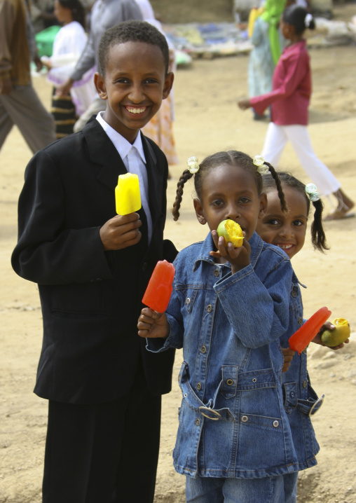 Eritrean children eating ice creams during mariam dearit festival, Anseba, Keren, Eritrea