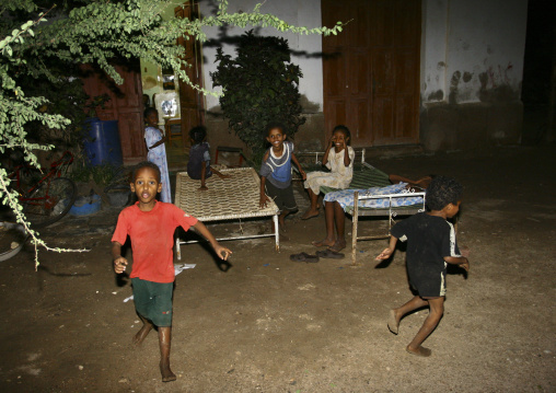 Ertrean children playing in front of their house at night, Northern Red Sea, Massawa, Eritrea