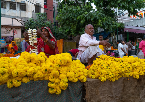 Indian people selling yellow flowers near a temple, Rajasthan, Jaipur, India