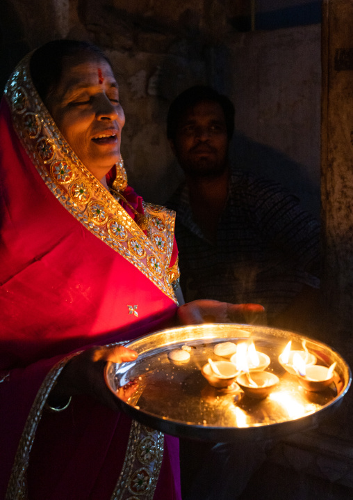 Indian woman offering candles for Diwali, Rajasthan, Jaipur, India