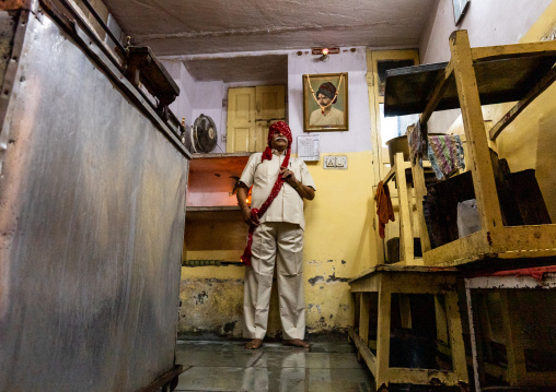 Indian man putting his turban in his shop, Rajasthan, Jaipur, India