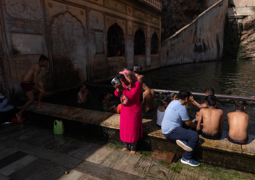 Indian pilgrims having a bath in Galtaji temple aka monkey temple, Rajasthan, Jaipur, India