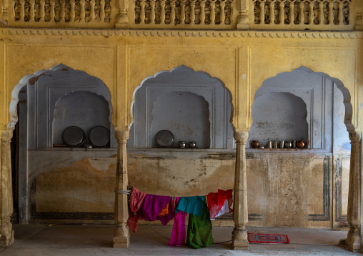 Steel cups in a niche inside Galtaji temple, Rajasthan, Jaipur, India