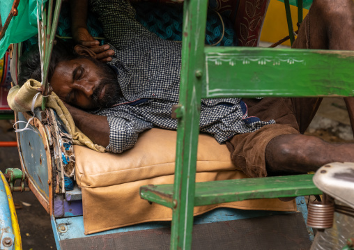 Indian driver sleeping in his rickshaw, Pondicherry, Puducherry, India
