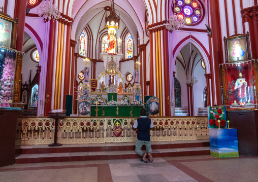 Indian man praying in t Basilica of the Sacred Heart of Jesus, Puducherry, Pondicherry, India