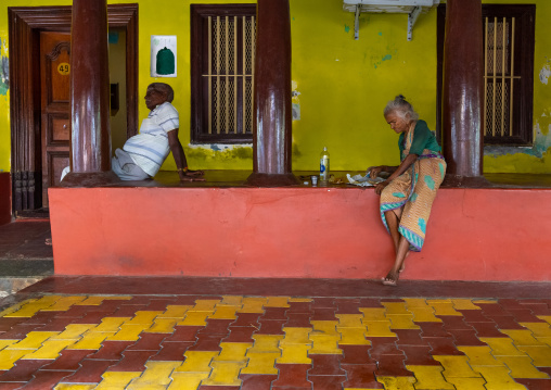 Old indian woman eating in her courtyard, Pondicherry, Puducherry, India