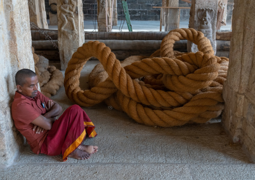 Indian sit near a huge rope in Sri Ranganathaswamy Temple, Tamil Nadu, Tiruchirappalli, India