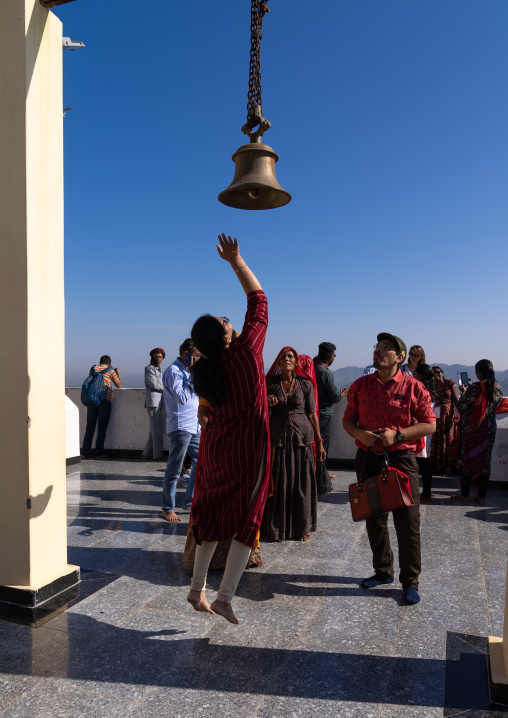 Indian people ringing bell in Savitri Temple, Rajasthan, Pushkar, India