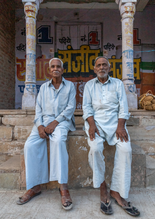 Indian senior men sit in the street, Rajasthan, Mukundgarh, India