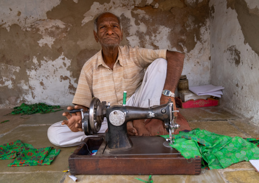 Indian tailor working in his workshop, Rajasthan, Bissau, India