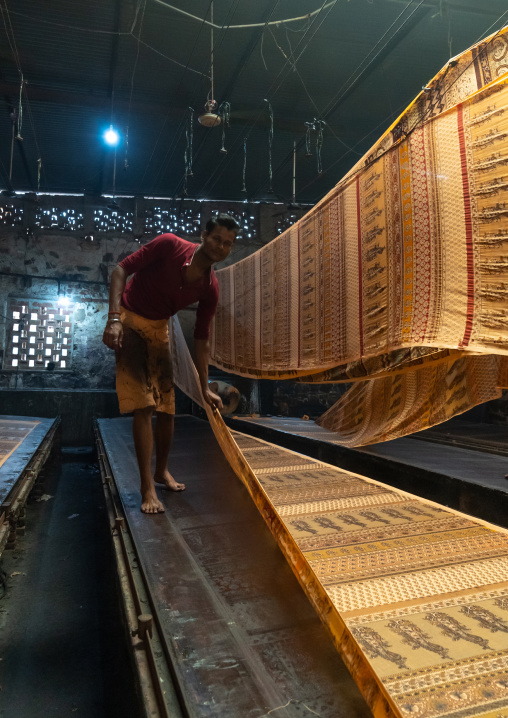 Indian worker drying textiles after manual Screen Printing, Rajasthan, Jaipur, India
