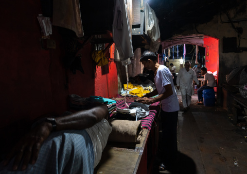 Laundry Worker ironing in Dhobi Ghat, Maharashtra state, Mumbai, India