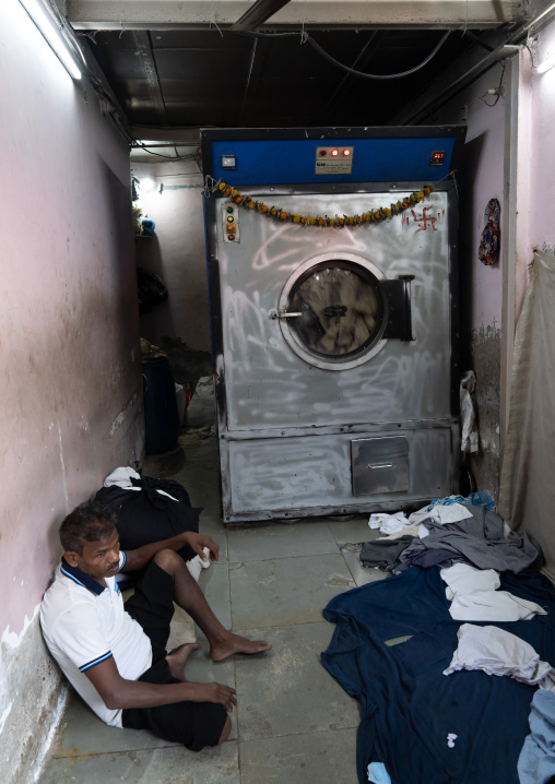 Laundry Worker with washing machine in Dhobi Ghat, Maharashtra state, Mumbai, India