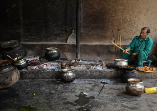 Kashmiri man preparing kebab skewers in a kitchen, Jammu and Kashmir, Srinagar, India