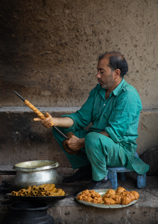 Kashmiri man preparing kebab skewers in a kitchen, Jammu and Kashmir, Srinagar, India