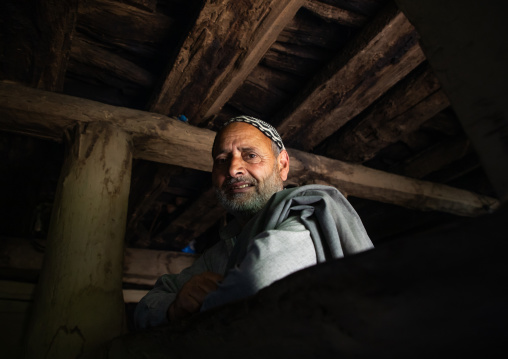 Portrait of a Gujjar Bakerwal man in his wooden house, Jammu and Kashmir, Kangan, India