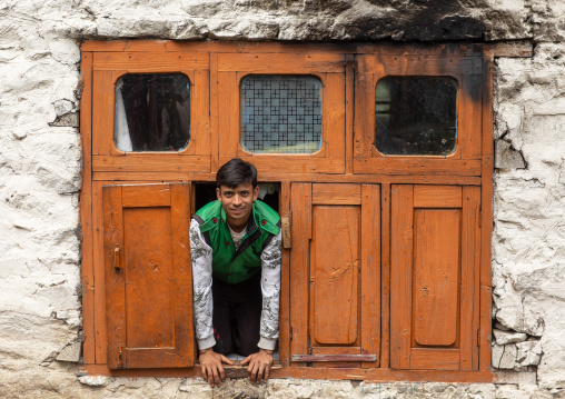 Kashmiri boy standing at the window of his house, Jammu and Kashmir, Kangan, India