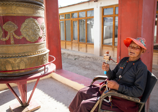 Tibetan man with a prayer wheel in Sonamling Tibetan settlement, Ladakh, Leh, India