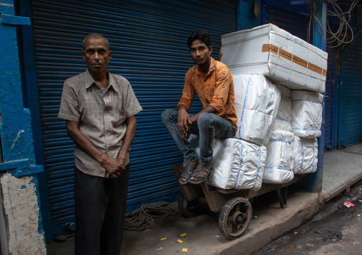 Indian men waiting to deliver packs in old Delhi, Delhi, New Delhi, India