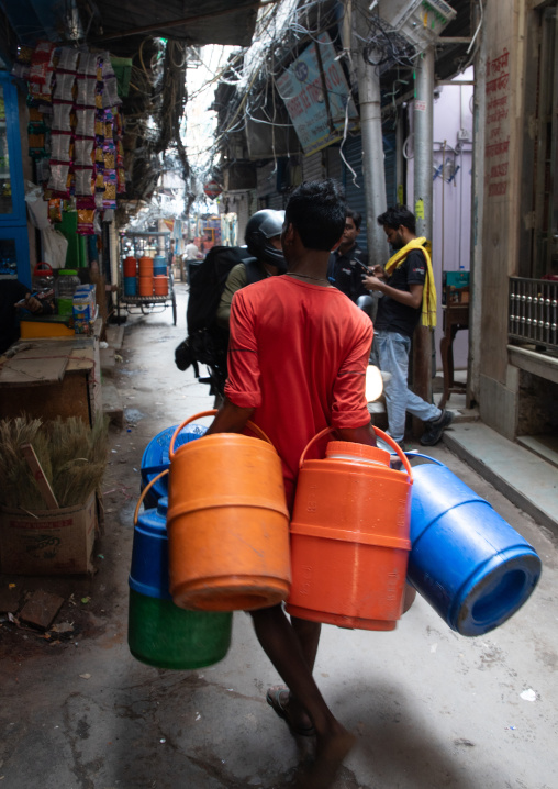 Indian man delivering drinking water in jerricans , Delhi, New Delhi, India