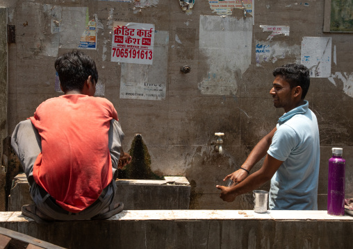 Indian men celaning glasses with water in old Delhi, Delhi, New Delhi, India