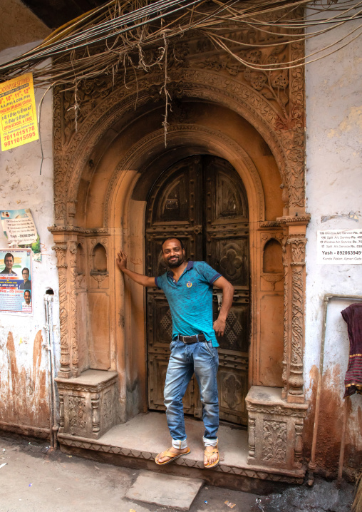 Man standing in front of a wooden door of an heritage house, Delhi, New Delhi, India