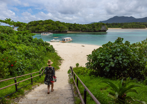 Tourists in tropical lagoon with clear blue water in Kabira bay, Yaeyama Islands, Ishigaki, Japan