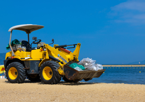 A bulldozer used to carry garbages in Momoshi beach, Kyushu region, Fukuoka, Japan