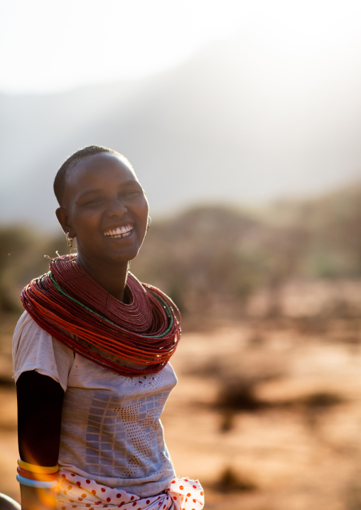 Portrait of a smiling Samburu woman with huge necklaces, Marsabit District, Ngurunit, Kenya