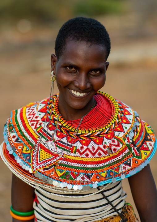 Portrait of a smiling Samburu woman with huge necklaces, Marsabit District, Ngurunit, Kenya