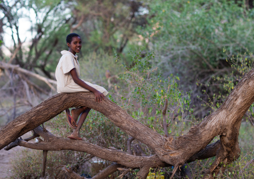 Portrait of a Samburu tribe girl sit on a trunk, Marsabit District, Ngurunit, Kenya