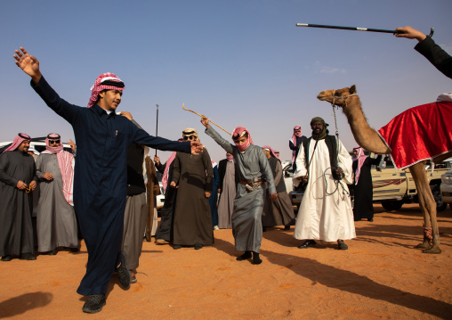 Saudi men dancing during King Abdul Aziz Camel Festival, Riyadh Province, Rimah, Saudi Arabia