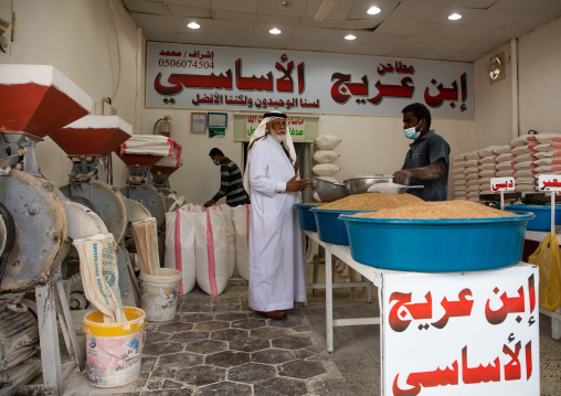 Saudi man buying cereals in a mill, Najran Province, Najran, Saudi Arabia