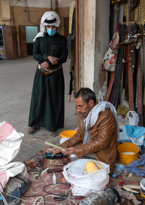 Saudi man buying a Jambyia in the souq, Najran Province, Najran, Saudi Arabia