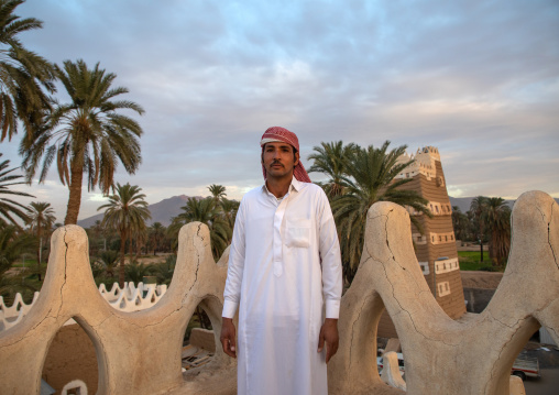 Saudi man on the terrace of his traditional mud houses, Najran Province, Najran, Saudi Arabia